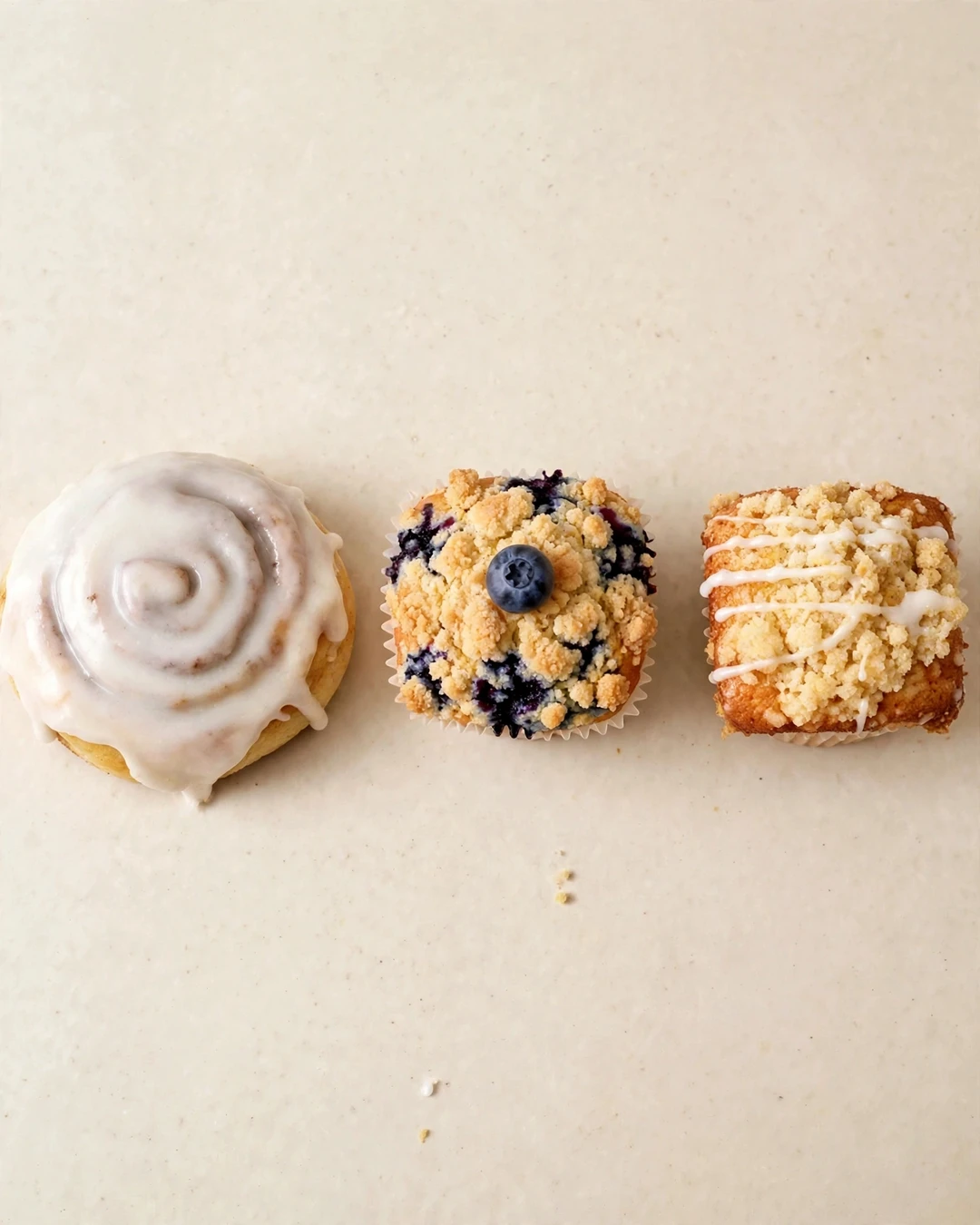 TWICE Baked Goods cinnamon rolls and muffins arranged together